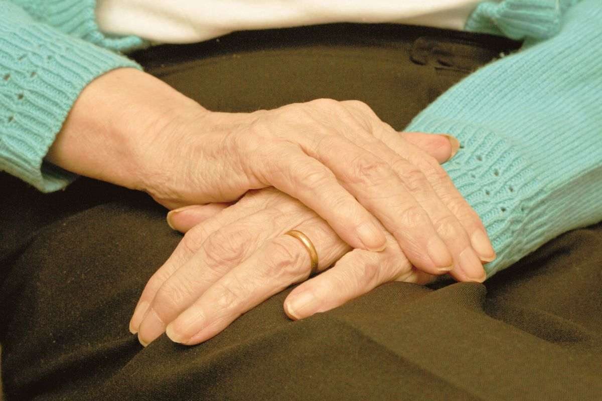 mani di donna anziana, una fede al dito